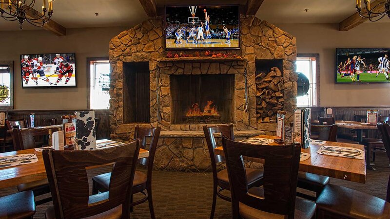 Dining room with fireplace and television