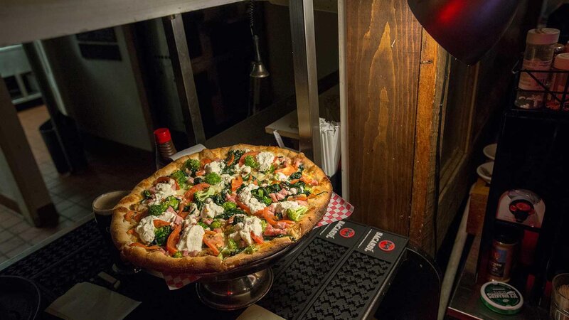 Pizza topped with chicken and vegetables